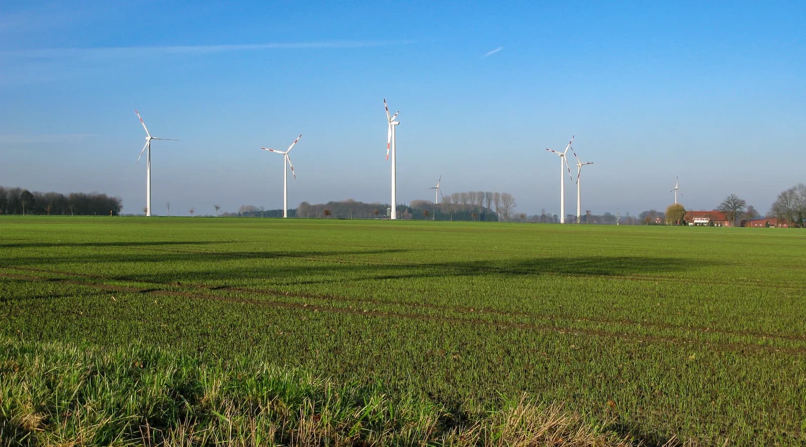 Wind turbines across open farmland in Germany.